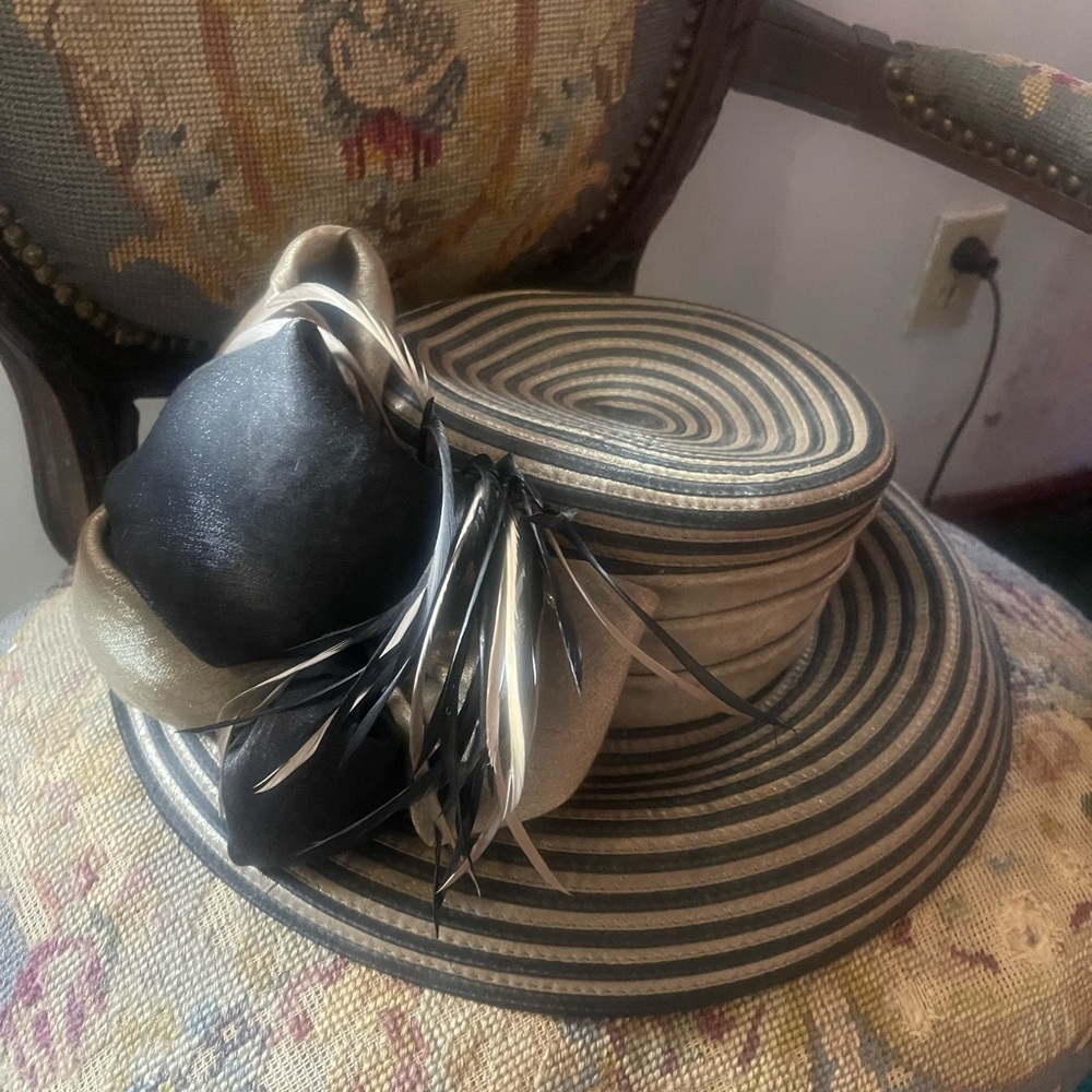 Fancy black, and gold hat with a feather